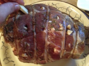 I quarter garlic and insert into the meat