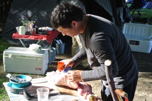Preparing his meats for the fire.