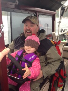 My youngest Mady at the wheel with her daddy.  Good thing I have my rain jacket on.